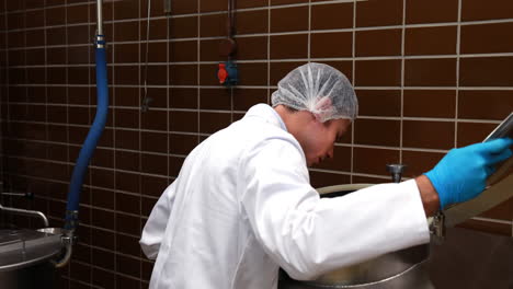 Brewery-worker-checking-the-product