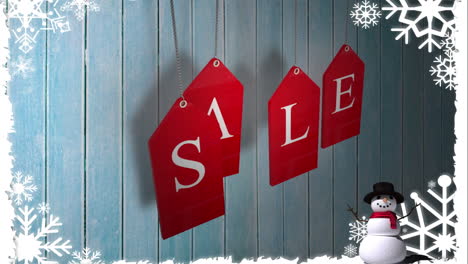 Red-sale-tags-hanging-against-wood-with-festive-border