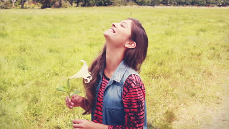 Pretty-brunette-smelling-a-flower