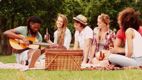 In-slow-motion-happy-friends-in-the-park-having-picnic