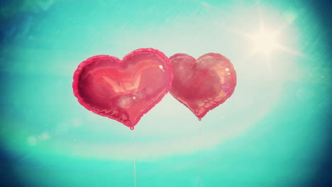 Heart-balloons-floating-against-blue-sky