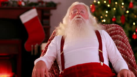 Tired-santa-sitting-down-in-armchair