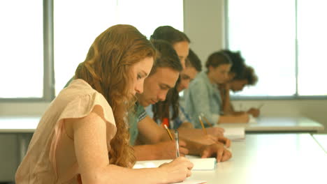 Students-taking-notes-in-lecture