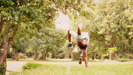 In-slow-motion-cool-young-break-dancer-doing-back-flip-in-the-park