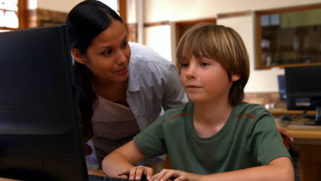 Pupil-and-teacher-in-computer-class-at-school