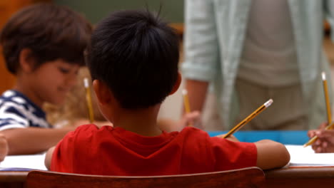 Cute-pupils-in-classroom-at-school