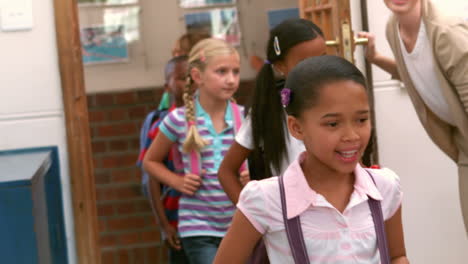 Cute-pupils-walking-into-classroom