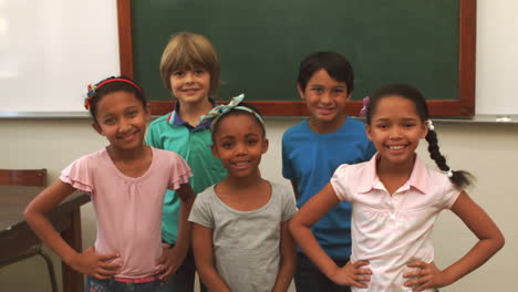 Cute-pupils-smiling-at-camera-in-classroom