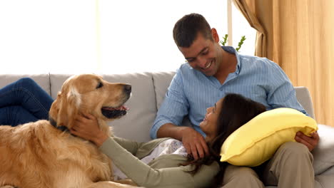 Happy-couple-with-their-dog-at-home