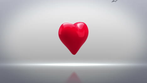 Red-heart-turning-and-exploding-on-grey-background
