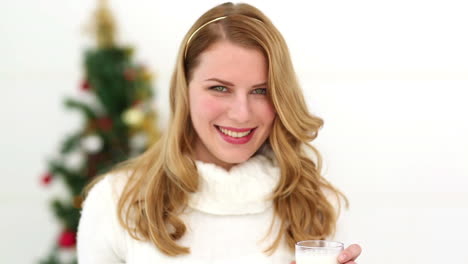 Festive-blonde-offering-milks-and-cookies