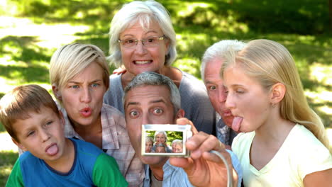 In-slow-motion-man-taking-picture-of-his-cheerful-extended-family-