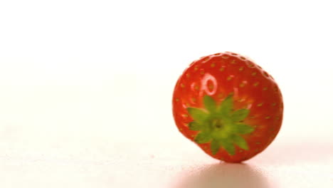 Strawberry-spinning-on-white-surface