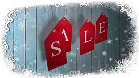 Red-sale-tags-hanging-against-wood-with-festive-border