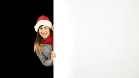 Beauty-brunette-in-santa-hat-showing-white-poster