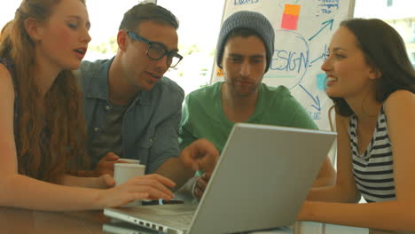 Students-using-laptop-together-during-meeting