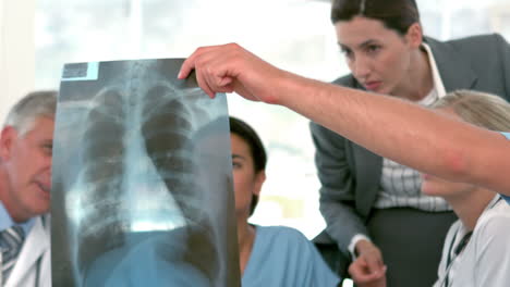 Medical-team-looking-at-Xray-during-meeting-