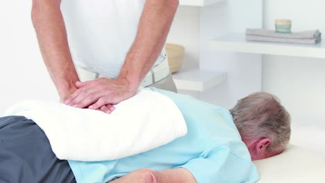 Physiotherapist-doing-back-massage-to-his-patient