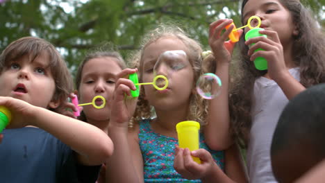 Happy-child-making-bubbles-in-the-park