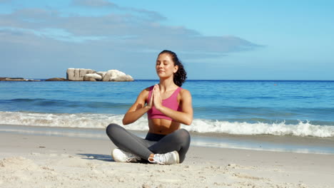 Mujer-En-Forma-Meditando-En-La-Playa