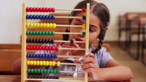 Cute-pupil-learning-maths-with-an-abacus-