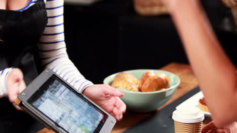 Waitress-and-customer-using-tablet-