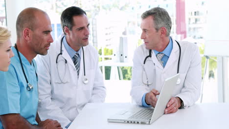 Medical-team-looking-at-laptop-computer