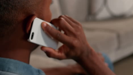 Man-talking-on-the-phone-in-living-room