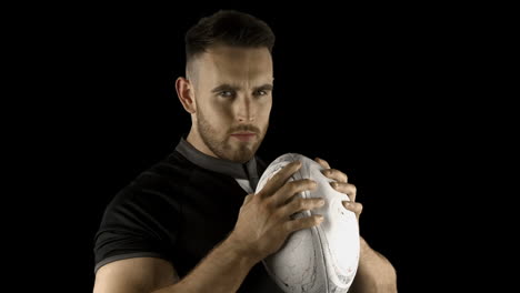 Serious-rugby-player-holding-ball