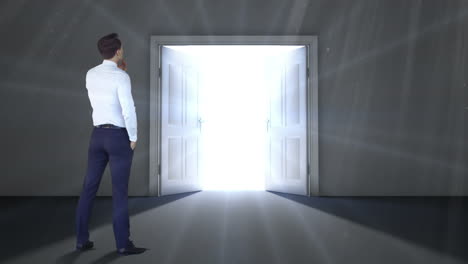 Businessman-watching-door-open-to-light