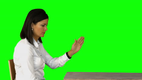 Irritated-businesswoman-sitting-on-chair-on-green-screen-