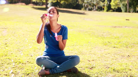 Pretty-woman-blowing-bubbles-in-the-park