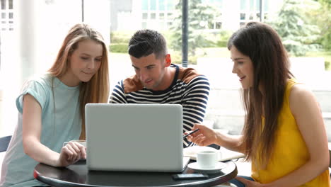 Students-hanging-out-in-campus-cafe-using-laptop