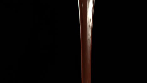 Melted-chocolate-pouring-on-black-background