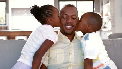 Father-and-children-sitting-on-couch-