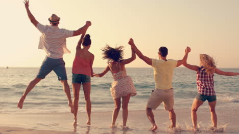 Group-of-friends-jumping-together-on-the-beach