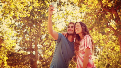 Happy-couple-taking-a-selfie-in-the-park