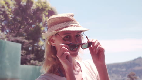 Attractive-blonde-with-hat-taking-off-sunglasses