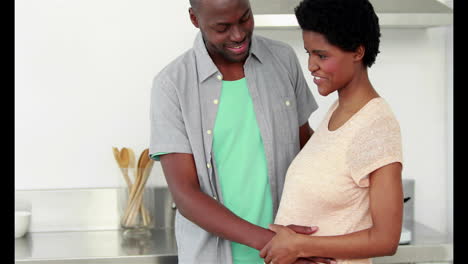 Man-embracing-his-happy-pregnant-wife