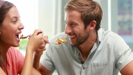 Happy-couple-sharing-a-desert