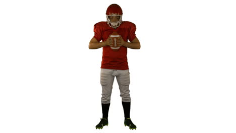 Red-american-football-player-holding-a-ball