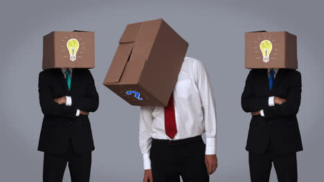Team-of-businessman-hiding-head-with-box-