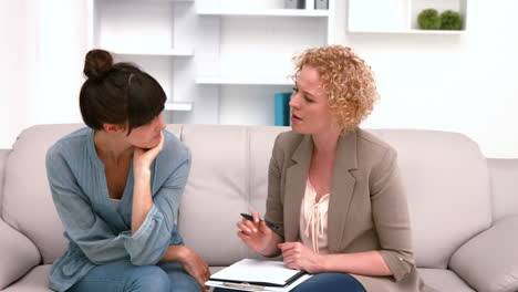 Psychologist-talking-with-her-depressed-patient-and-taking-notes