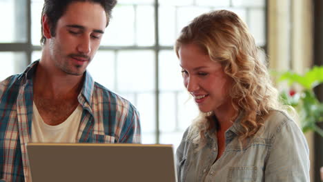 Casual-business-team-having-a-meeting-using-laptop