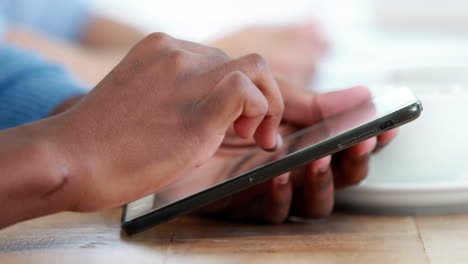 Close-up-view-of-businessman-using-tablet-computer