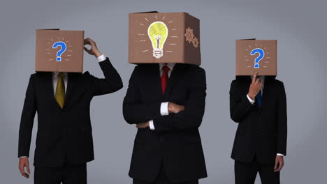 Team-of-businessman-hiding-head-with-box-and-gesturing
