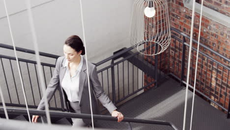 Pretty-businesswoman-climbing-the-stairs