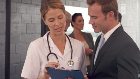 Doctors-discussing-the-report-on-clipboard