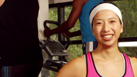 Fit-woman-with-headband-smiling-at-camera