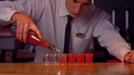 Bartender-pouring-shots-on-counter